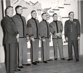 Fort Slocum's commanding officer, Col. Frank Castagneto (right), with a group of visiting West Point cadets in front of a map of South Asia, ca. 1963.