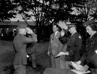 A soldier salutes Colonel Bernard Lentz (center right), Fort Slocum’s commanding officer, 1945. The occasion is a graduation exercise for the honor battalion of the Second Service Command’s Rehabilitation Center, which operated at Fort Slocum from late 1944 until mid-1946. The civilian to the left of Col. Lentz is Stanley Church, New Rochelle’s mayor. Capt. Eunity Frances Elderdice stands to Col. Lentz’s right.